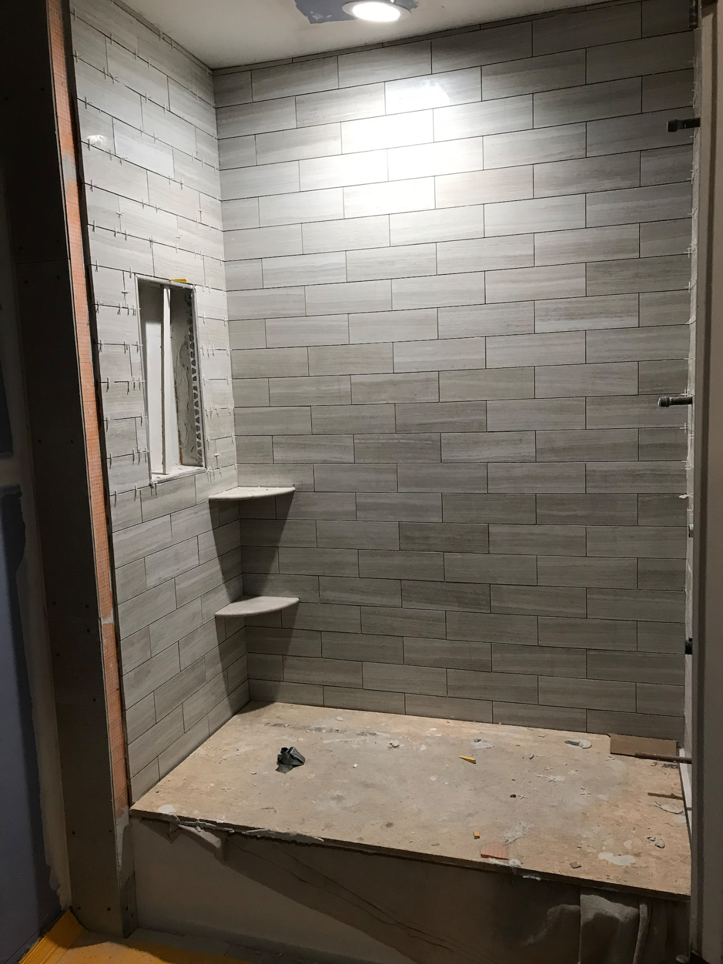 Large walk-in shower with porcelain tile under construction