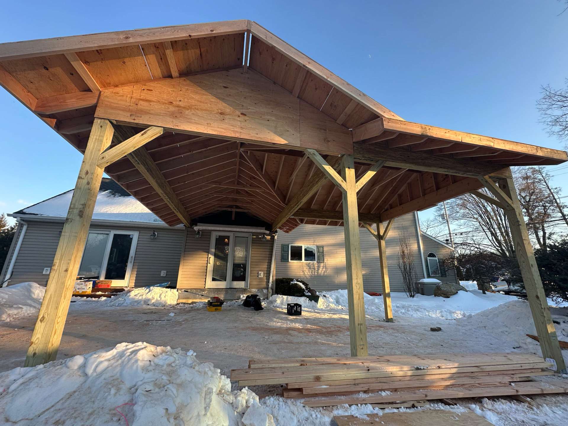 Timber-framed covered entry structure under construction
