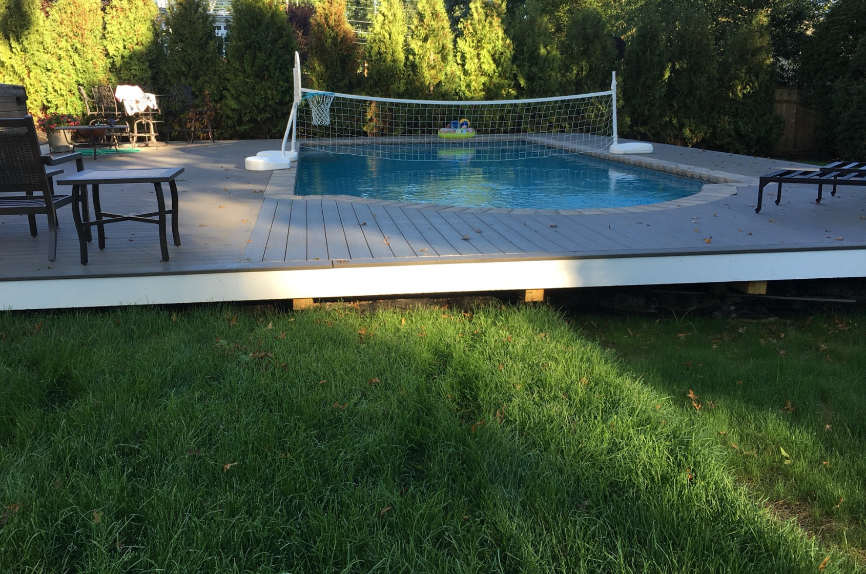 Composite deck surrounding a backyard pool